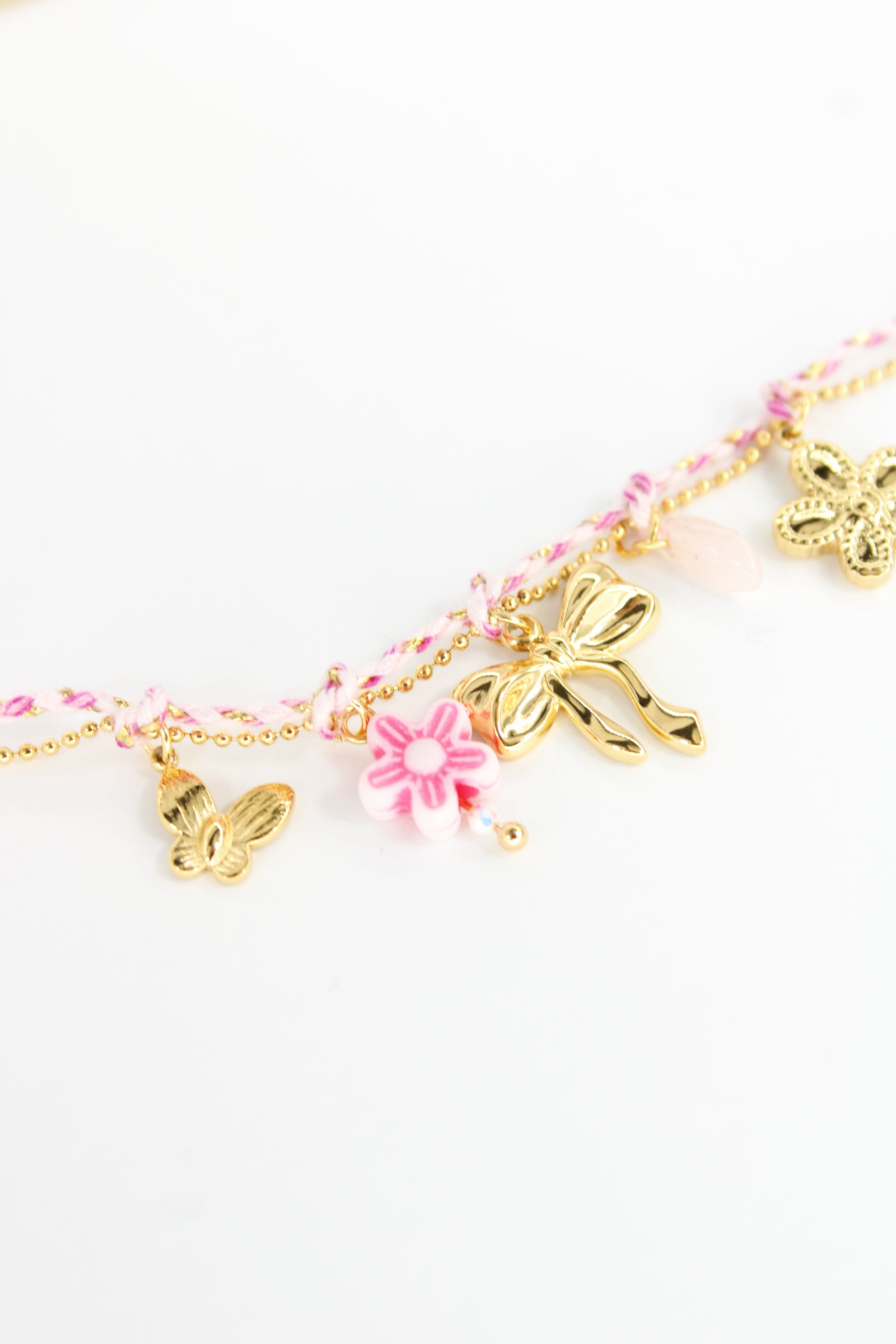 Bracelet Margaret cordon et charms papillon, fleur et nœud en acier inoxydable – Rose ou bleu – Bijou femme Langon